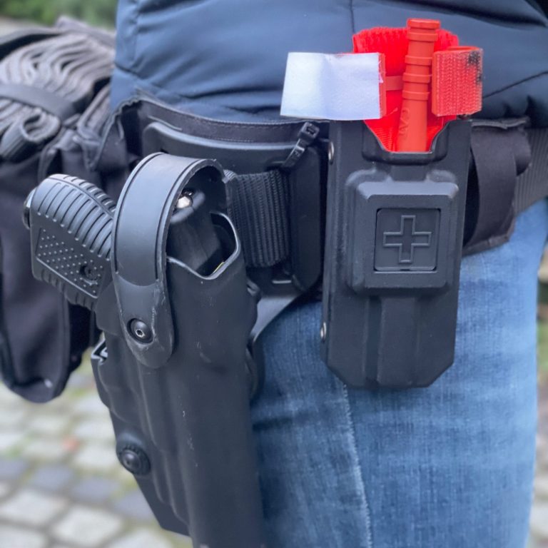 Dienstkoppel an der Hüfte. Ausgestattet mit Tournieret und Waffe 