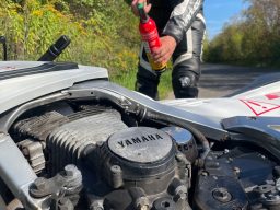 Simulationsmotorrad Brennt Simulationsmotorrad Bloody Betty brennt. Ein Biker löscht mit einem Feuerlöscher